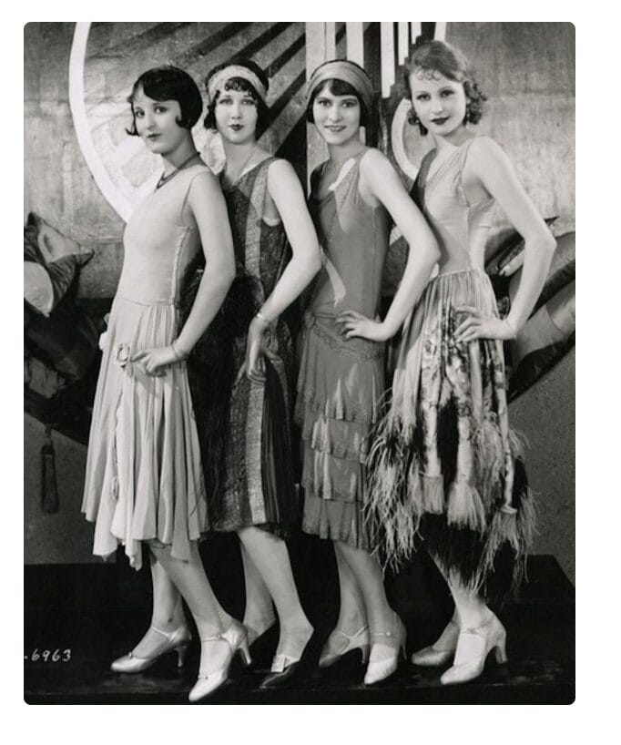 photo of four young women posing in flapper attire